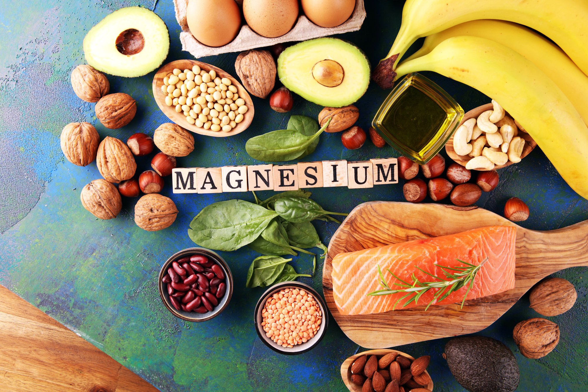 magnesium-rich foods around text tiles spelling out "magnesium" 