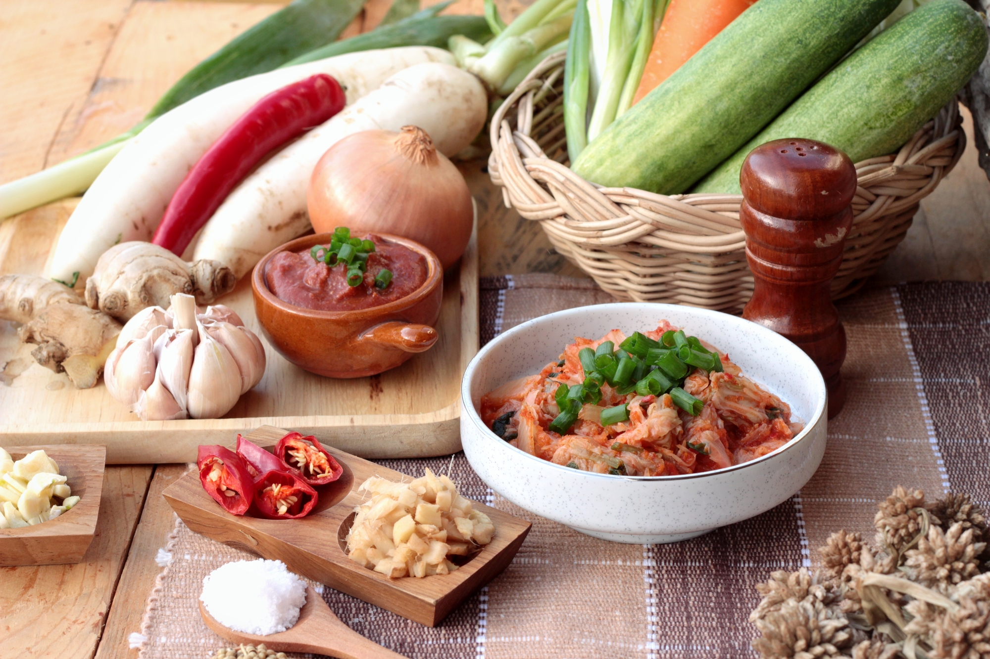 Probiotics and prebiotics on a table, like kimchi and garlic