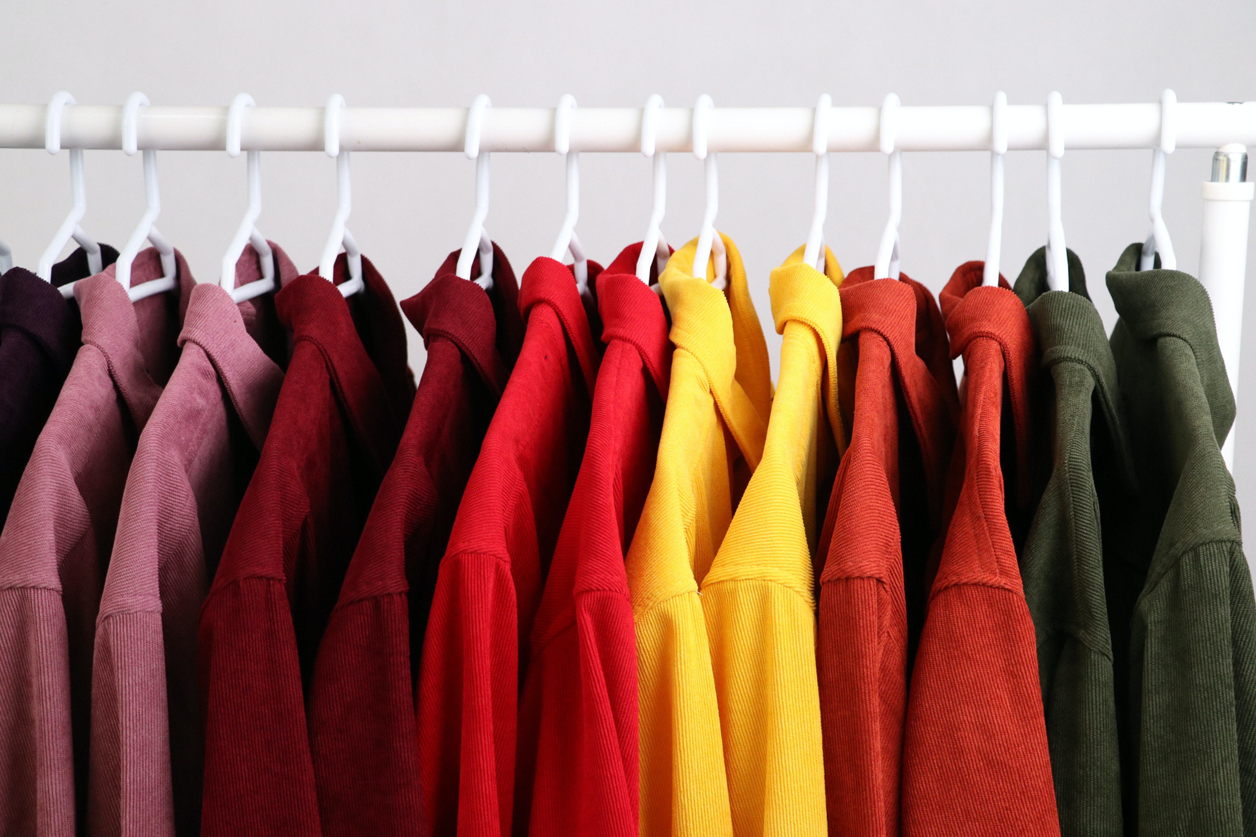 a rack of bright coloured shirts