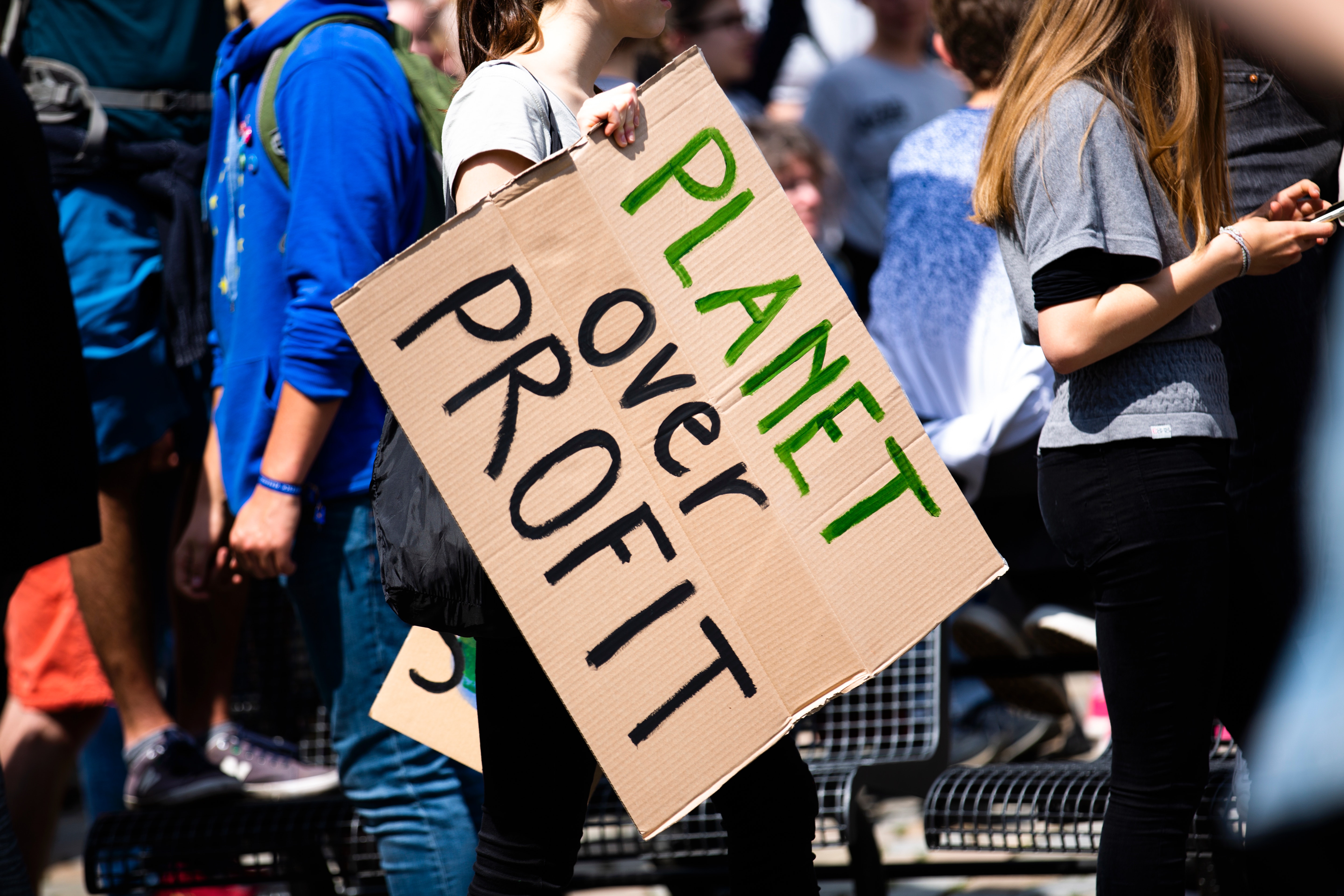 Sustainability in the Fashion Industry: Protest sign saying "Planet over Profit"