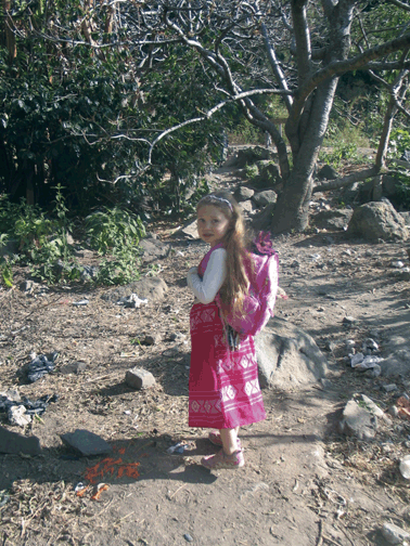 small girl on a path in the woods