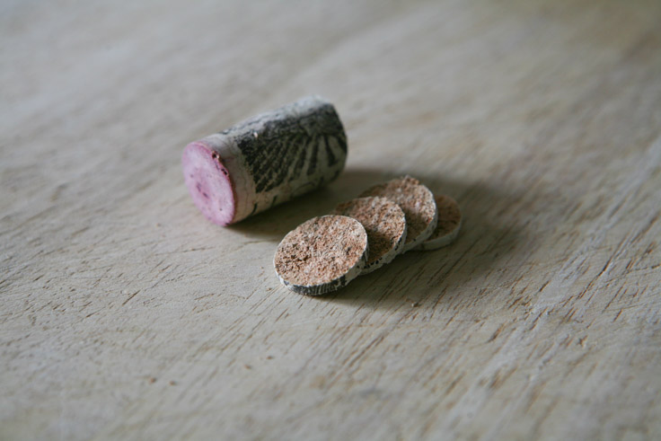 carefully slice cork with serrated knife into thin discs