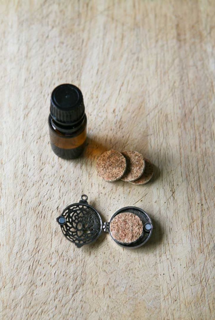 add essential oil to cork pad, insert into pendant