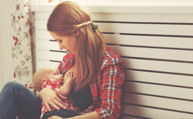 woman in plaid shirt breastfeeding
