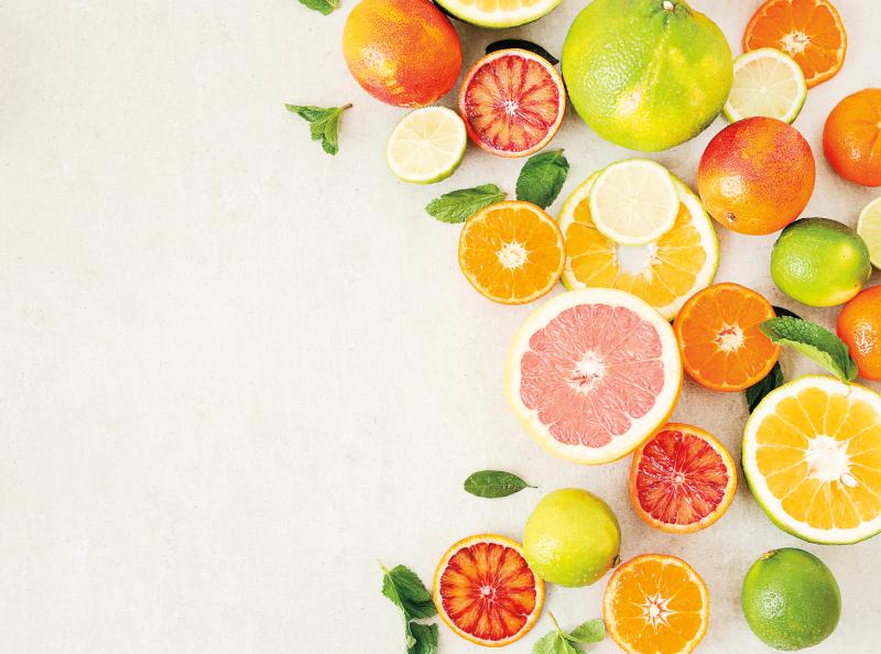 assortment of citrus fruits cut open and arranged in a crescent shape