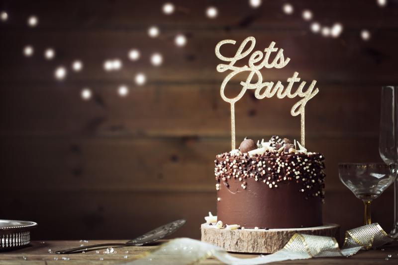 chocolate cake with a candle that says "let's party"