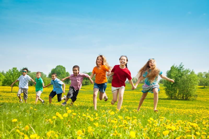 Five Ways to Connect with Environmental Organizations: group of kids running in a field of yellow flowers