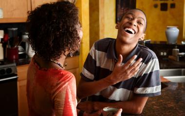 young black man laughing with his mother
