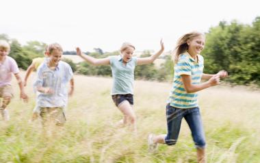 kids running through tall grass
