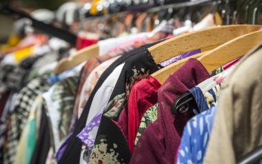 The Sustainable Fashion Movement in Canada: rack of second-hand clothing on hangers