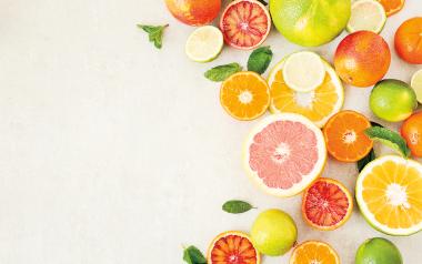 assortment of citrus fruits cut open and arranged in a crescent shape