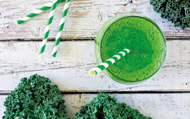 green smoothie with striped green straw viewed from above