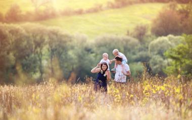 family walking through a wildflower field