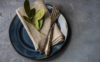 plate with napkin fork and leaves on top