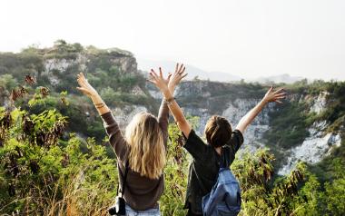 two women with backpacks and travel gear