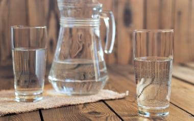 a pitcher and two glasses of water