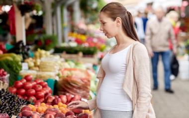 pregnant woman choosing fresh market produce