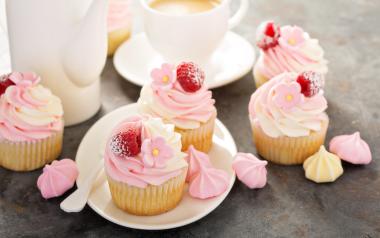cupcakes with pink frosting and a berry on top