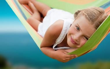 young girl lying in hammock