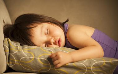 small girl sleeping on a couch