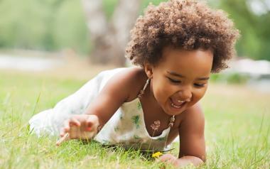 toddler playing in the grass