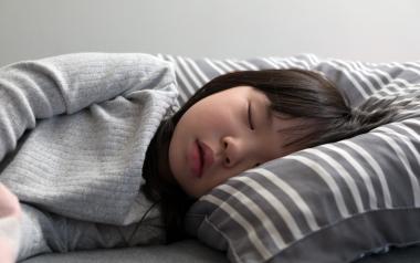 child sleeping on the bed in her bedroom