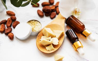assortment of natural beauty ingredients almonds, oils, beeswax