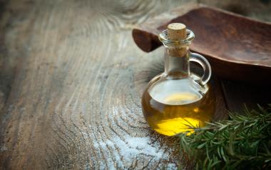 bottle of olive oil on wooden background