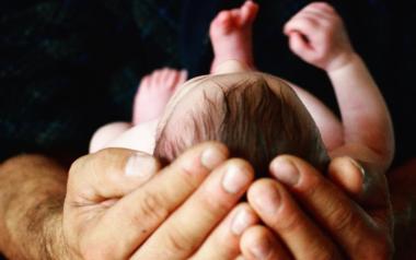 What Craniosacral Therapy Can Do For Newborns: Man's hands holding baby