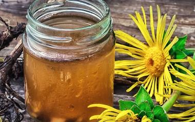 A mason jar filled with a liquid herbal remedy