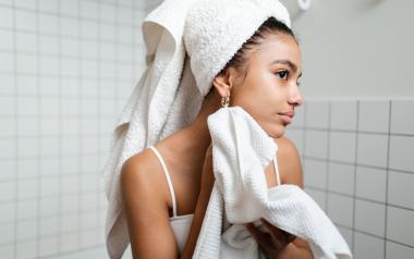 A teen practices skin care