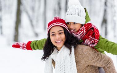 a child and mother enjoy winter outdoors together