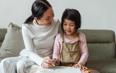 a mom guides her child in a drawing activity