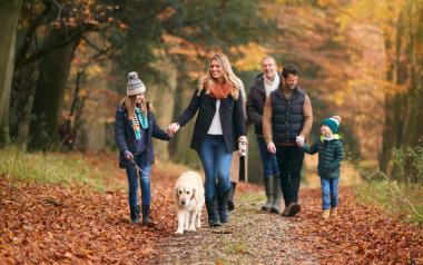 A multi-generational family enjoys a fall walk