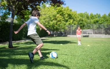 children play soccer in the summer