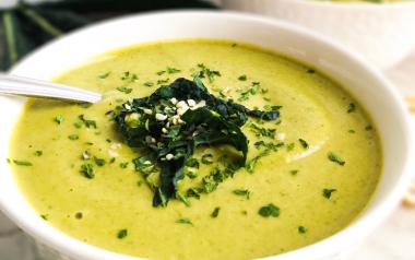 Broccoli Kale Soup in a white bowl garnished with kale