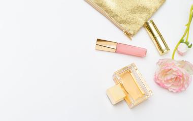 Natural makeup: Various beauty products with a gold pouch on a white table
