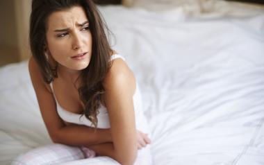 Treat Premenstrual Symptoms Naturally With Food Swaps: woman with cramps