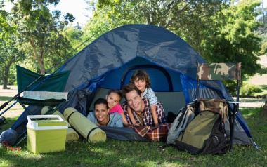 Camping Health Benefits: Smiling family in tent
