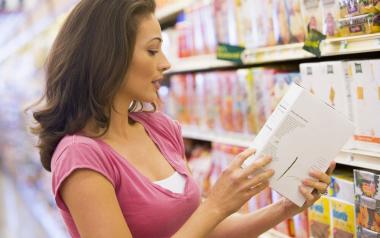 Additives in Food That Can Affect Your Child’s Behaviour: Woman reading product ingredients at grocery store