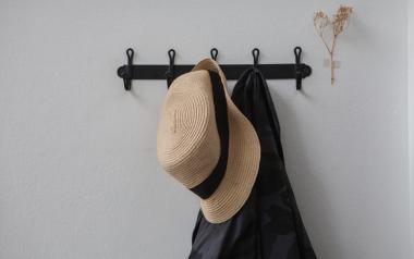 hat and coat hanging on a wall rack