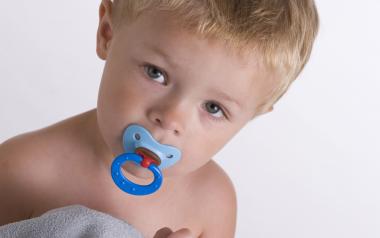 How to Wean Babies Off Pacifiers: toddler sucking on soother