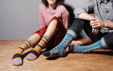 How to Stay Warm this Winter and Save on Energy: Two kids sitting and wearing colourful socks
