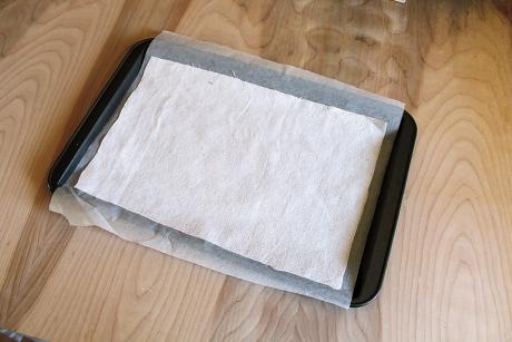 lay parchment paper and fabric on pan