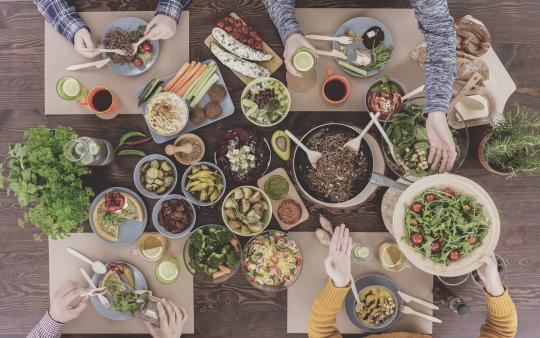 full dinner table with family seated looking from above