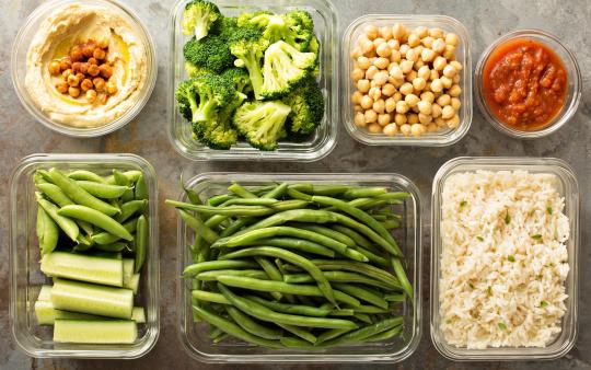 portions of healthy food laid out in a grid of glass containers