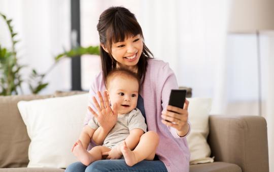 woman taking a selfie with her baby