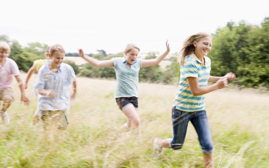 kids running through tall grass