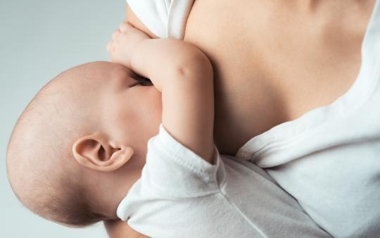 baby nursing at mother's breast