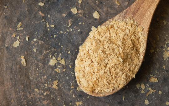 wooden spoon full of nutritional yeast